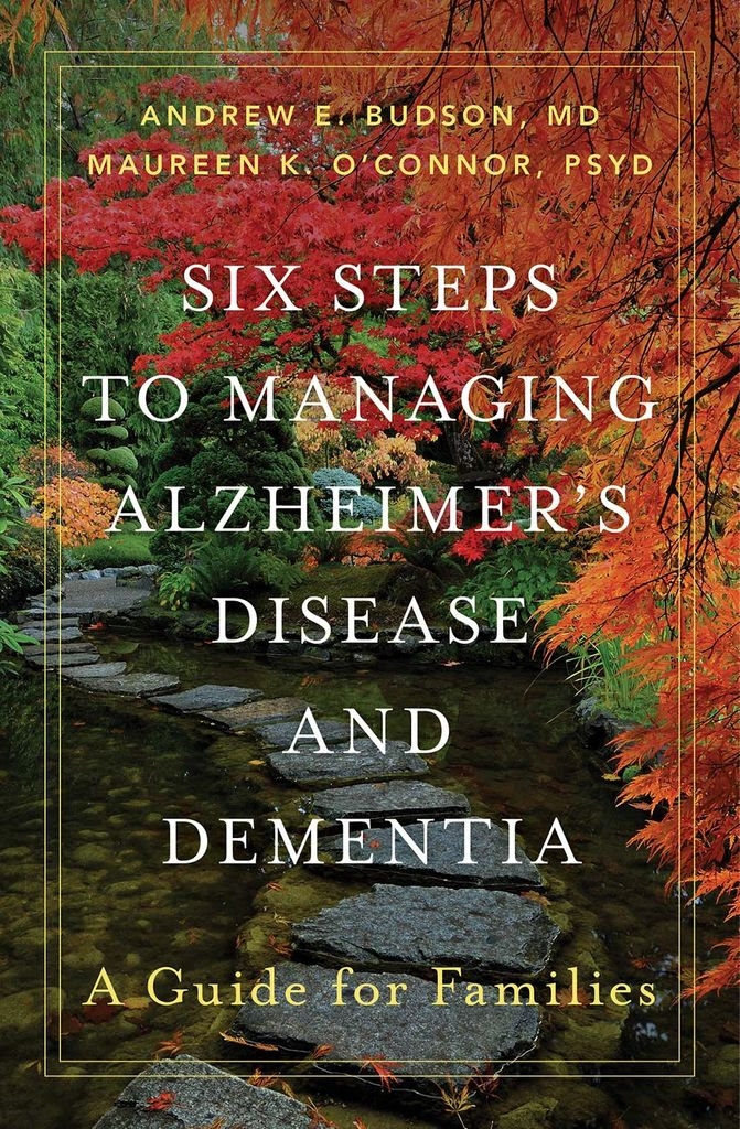 Book cover for Andrew E. Budson, MD and Maureen K. O’Connor, PSYD’s “Six Steps to Managing Alzheimer’s Disease and Dementia: A Guide for Families.” Photo shows a stepping stone path in the middle of a stream. Fall foliage is seen on either side of the stream.